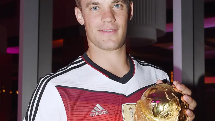 epa04315306 A handout photo released by the DFB (German Soccer Association) on 14 July 2014 shows German goal keeper Manuel Neuer celebrating Germany's victory over Argentina in the Soccer World Cup 2014 with the trophy in Rio De Janeiro, Brazil, 13 July 2014. Germany won the World Cup after defeating Argentina 1-0. EPA/MARKUS GILLIAR / DFB / HANDOUT HANDOUT EDITORIAL USE ONLY/NO SALES