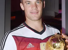epa04315306 A handout photo released by the DFB (German Soccer Association) on 14 July 2014 shows German goal keeper Manuel Neuer celebrating Germany's victory over Argentina in the Soccer World Cup 2014 with the trophy in Rio De Janeiro, Brazil, 13 July 2014. Germany won the World Cup after defeating Argentina 1-0. EPA/MARKUS GILLIAR / DFB / HANDOUT HANDOUT EDITORIAL USE ONLY/NO SALES