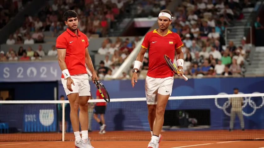 epa11513047 Carlos Alcaraz and Rafael Nadal of Spain react during the Men's Doubles Quarter-final match against Austin Krajicek and Rajeev Ram of the US at the Tennis competitions in the Paris 2024 Olympic Games, at the Roland Garros in Paris, France, 31 July 2024. EPA/DANIEL IRUNGU