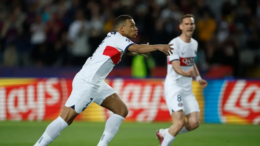 epa11283234 PSG's Kylian Mbappe celebrates scoring the 1-3 goal during the UEFA Champions League quarter finals second leg soccer match between FC Barcelona and Paris Saint-Germain, in Barcelona, Spain, 16 April 2024. EPA/Alberto Estevez