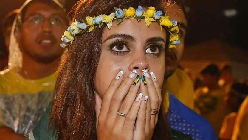 epa04306784 A fan of Brazil reacts during the viewing of the FIFA World Cup 2014 semi final match between Brazil and Germany at the FIFA Fan Fest on the Copcabana in Rio De Janeiro, Brazil, 08 July 2014. Germany won the match 7-1. EPA/KAMIL KRZACZYNSKI