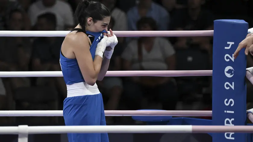 Imane Khelif of Algeria (unseen) and Angela Carini of Italy ( Blue) in action during their women's 66kg preliminar round of 16 bout of the Boxing competitions in the Paris 2024 Olympic Games, at the North Paris Arena in Villepinte, France, 1 August 2024 . ANSA / CIRO FUSCO