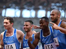 (From L) Italy's Filippo Tortu, Italy's Lorenzo Patta, Italy's Eseosa Fostine Desalu, and Italy's Lamont Marcell Jacobs pose after taking third place i the men's 4x100m relay heats during the Tokyo 2020 Olympic Games at the Olympic Stadium in Tokyo on August 5, 2021. (Photo by Jonathan NACKSTRAND / AFP)
