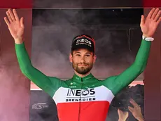 Italian rider Filippo Ganna of Ineos Grenadiers team celebrates on the podium after winning the 14th stage of the 107 Giro d'Italia 2024, an individual time trial (ITT) over 31.2 km from Castiglione delle Stiviere to Desenzano del Garda, Italy, 18 May 2024. ANSA/LUCA ZENNARO