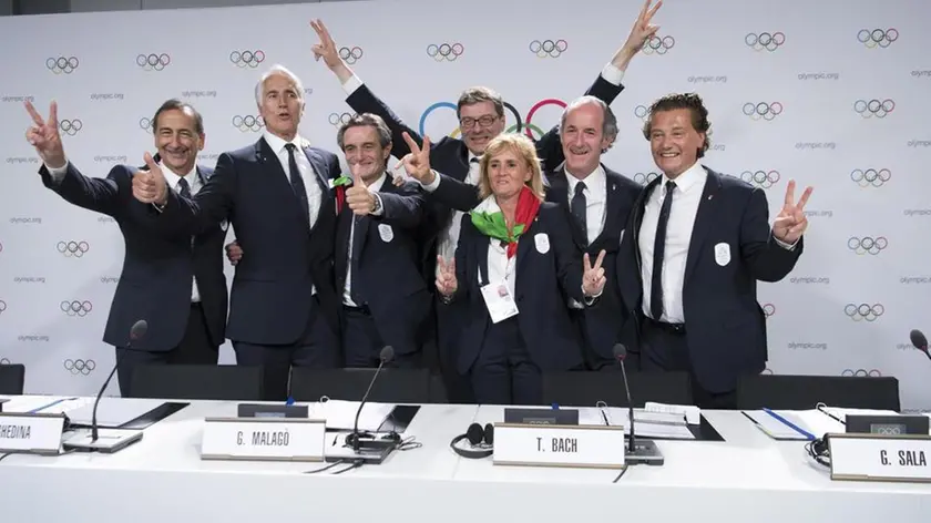 From left, the Mayor of Milan Giuseppe Sala, Italy's National Olympic Committee (CONI) president Giovanni Malago, Italy's Lombardy region President Attilio Fontana, Italy's Under Secretary of State Giancarlo Giorgetti, Italy's Olympic Gold Medallist in Fencing Diana Bianchedi, Italy's Veneto Region President Luca Zaia and Mayor of Cortina Gianpietro Ghedina pose after Milan-Cortina won the bid to host the 2026 Winter Olympic Games, during the first day of the 134th Session of the International Olympic Committee (IOC), at the SwissTech Convention Centre, in Lausanne, Switzerland, Monday, June 24, 2019. Italy will host the 2026 Olympics in Milan and Cortina d'Ampezzo, taking the Winter Games to the Alpine country for the second time in 20 years. (Laurent Gillieron/Keystone via AP)