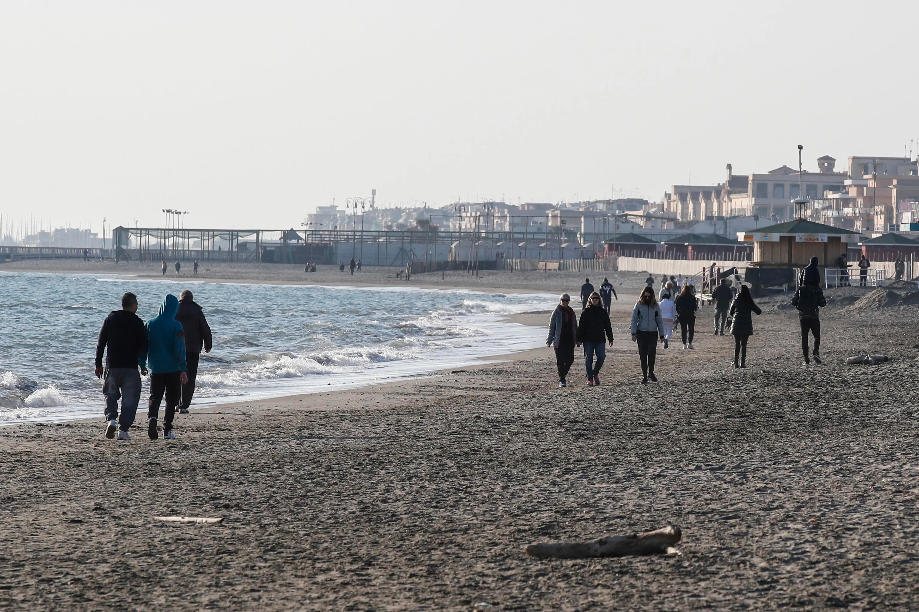 People walk in the Ostia beach during the emergency blockade of Covon-19 Coronavirus, Rome, Italy, 15 March 2020. ANSA/GIUSEPPE LAMI