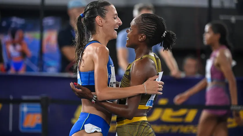 Faith Kipyegon (R) of Kenya celebrates with Nadia Battocletti (L) of Italy after winning in the women's 1500m race during the Diamond League Golden Gala athletics meeting at the Olimpico stadium in Rome, Italy, 30 August 2024. ANSA/RICCARDO ANTIMIANI