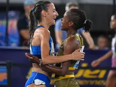 Faith Kipyegon (R) of Kenya celebrates with Nadia Battocletti (L) of Italy after winning in the women's 1500m race during the Diamond League Golden Gala athletics meeting at the Olimpico stadium in Rome, Italy, 30 August 2024. ANSA/RICCARDO ANTIMIANI