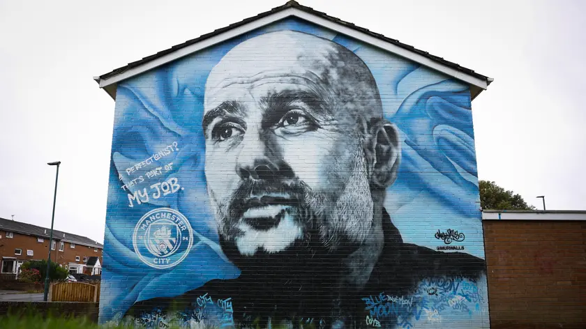 epa11605617 A mural of Manchester City manager Pep Guardiola near to the Etihad Stadium in Manchester, Britain, 15 September 2024. An independent hearing is set to begin on 16 September 2024 assessing over 100 alleged breaches of Premier League financial rules by Manchester City between 2009 and 2023. Manchester City have denied all charges, which allege that they failed to provide accurate financial information and to properly disclose player and manager payments over a period of nine seasons, that they did not comply with UEFA financial fair play regulation over a period of five years, that they breached Premier League profit and sustainability rules over three season and that they failed to cooperate with Premier League investigations. If found guilty Manchester City could face fines, a points deduction or even suspension or expulsion from the Premier League. EPA/ADAM VAUGHAN