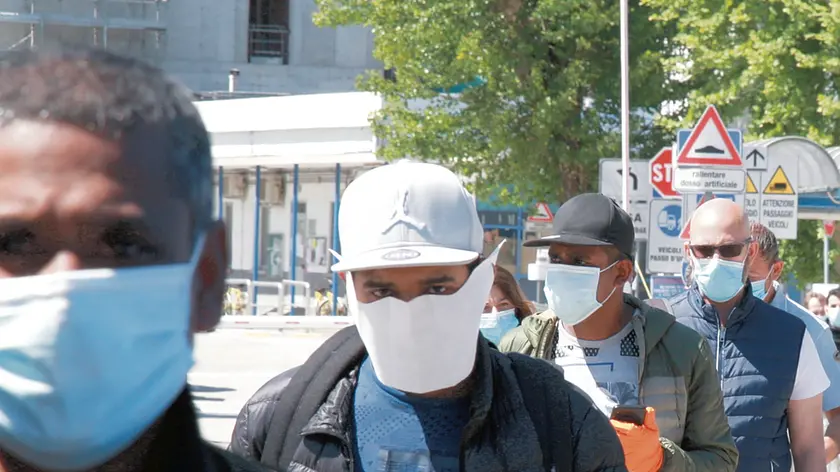 Alcuni operai al termine del turno di lavoro alla Fincantieri