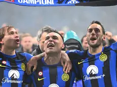 L to R Inter Milan’s Nicolò Barella,Lautaro Martinez and Hakan Çalhano?lu celebrate at the end of the Italian Serie A soccer match between Ac Milan and Inter Milan at the Giuseppe Meazza stadium in Milan, Italy, 22 April 2024. ANSA/DANIEL DAL ZENNARO