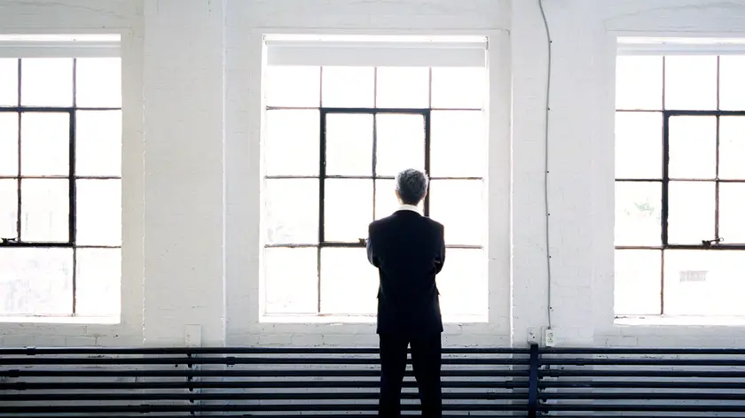 Businessman Standing in front of a Wall of Windows, Montreal, Quebec
