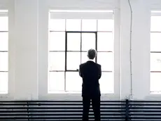 Businessman Standing in front of a Wall of Windows, Montreal, Quebec