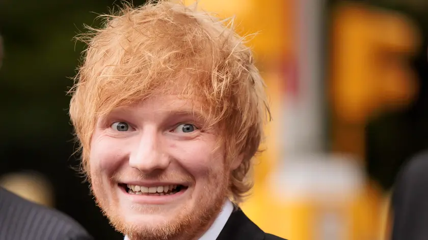 epa10608865 Musician Ed Sheeran smiles while standing with his legal team after winning his copyright infringement case in New York, New York, USA, 04 May 2023. Sheeran had been accused of copying portions of the Marvin Gaye song 'Let’s Get it On', which was co-written by Ed Townsend, in his song 'Thinking Out Loud'. EPA/JUSTIN LANE