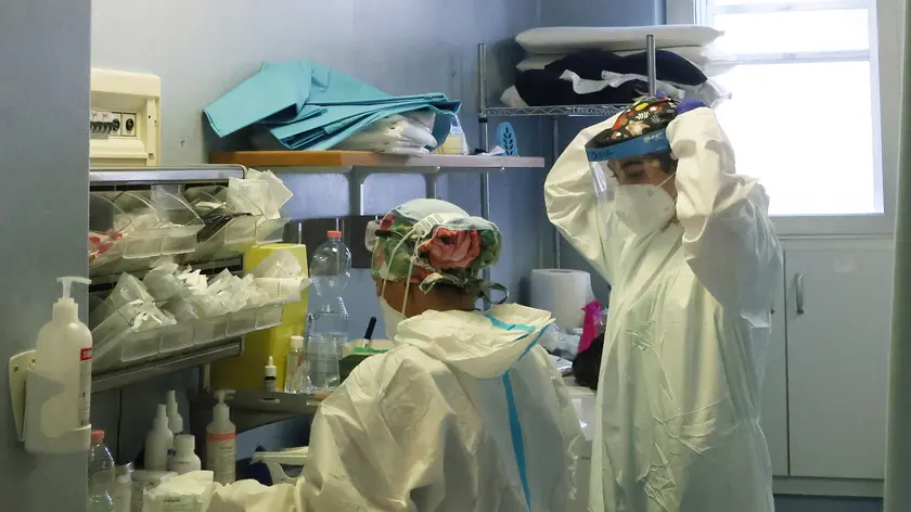 Health workers wearing overalls and protective masks at work in the intensive care unit of the hospital of Cremona amid the Covid-?19 coronavirus pandemic, in Cremona, northern Italy, 26 December 2021. Italian Premier Mario Draghi's government has brought in a series of new COVID-19 prevention measures, including the obligation to wear facemasks outdoors, due to the sharp upswing in contagion and the arrival of the Omicron variant. It was already mandatory for people to wear facemasks in enclosed public spaces. The government has also decide to close Italy's night clubs and dance halls and ban open-air parties that attract crowds of people until January 31. It has also reduced the duration of the 'Super Green Pass' health certificate for people who are vaccinated for the coronavirus from nine to six months. ANSA/ FILIPPO VENEZIA